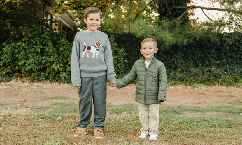 Older boy wearing a warm sweater and pants, toddler wearing a quilted puffy jacket and pants from Pedal Kidswear winter collection.